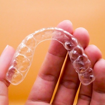 hand holding Invisalign