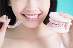 Woman holding orthodontic appliances 
