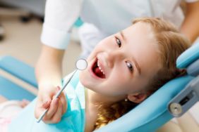 Smiling little girl getting a dental exam