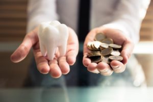 tooth in one hand, coins in the other 