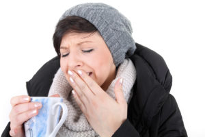 Woman with sensitive teeth in pain from hot tea