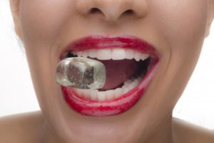 Closeup of woman chewing on ice